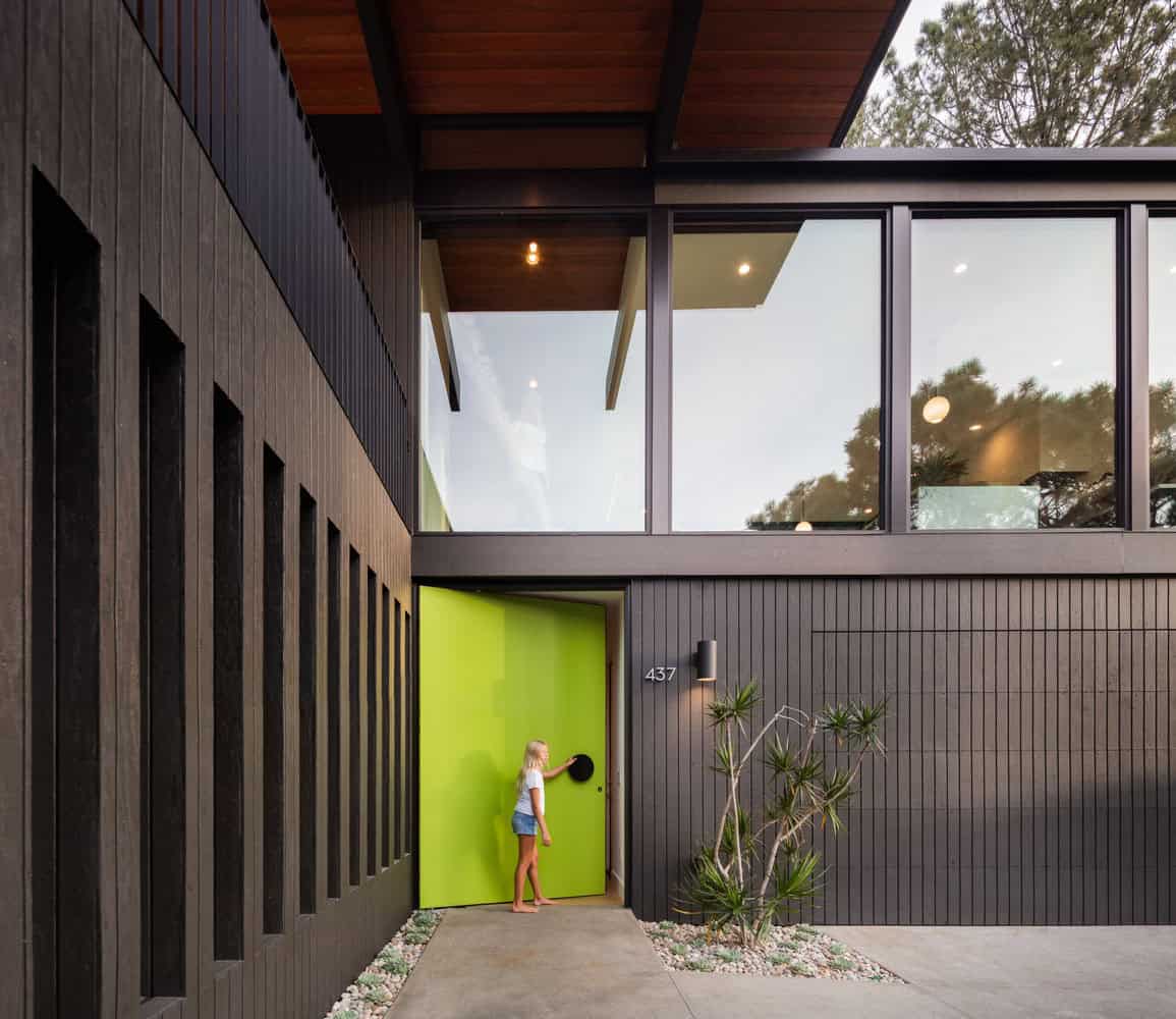midcentury modern home exterior entry with a green door