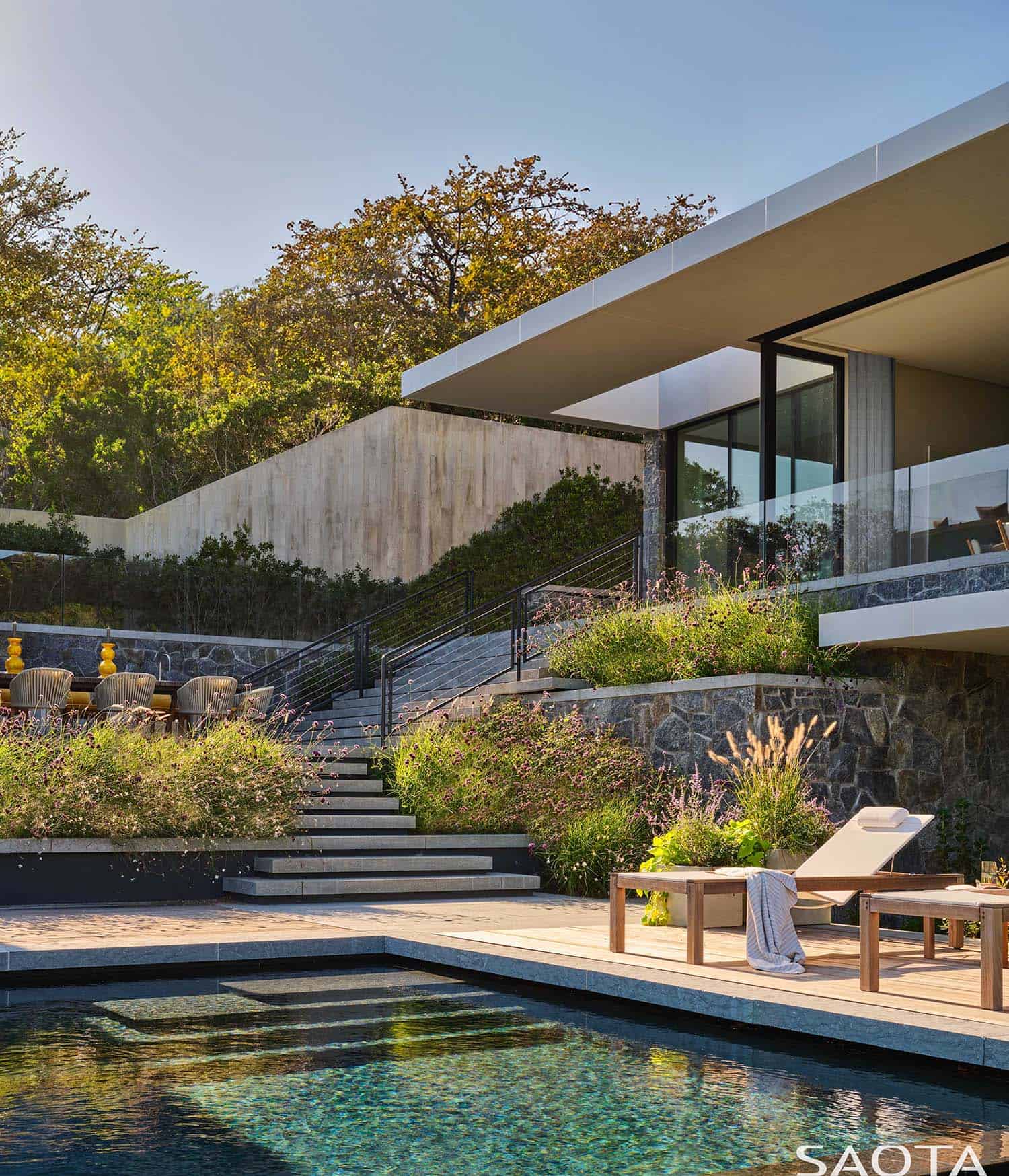 modern beach house exterior with a pool