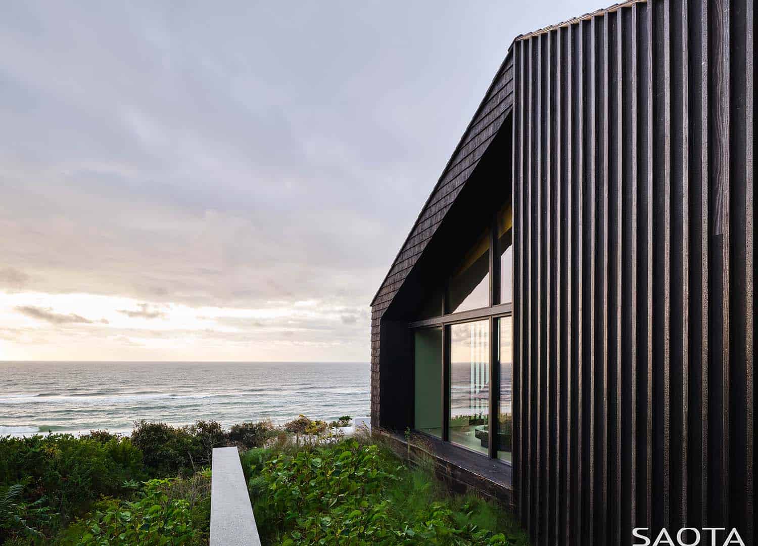 modern beach house exterior with a view of the ocean