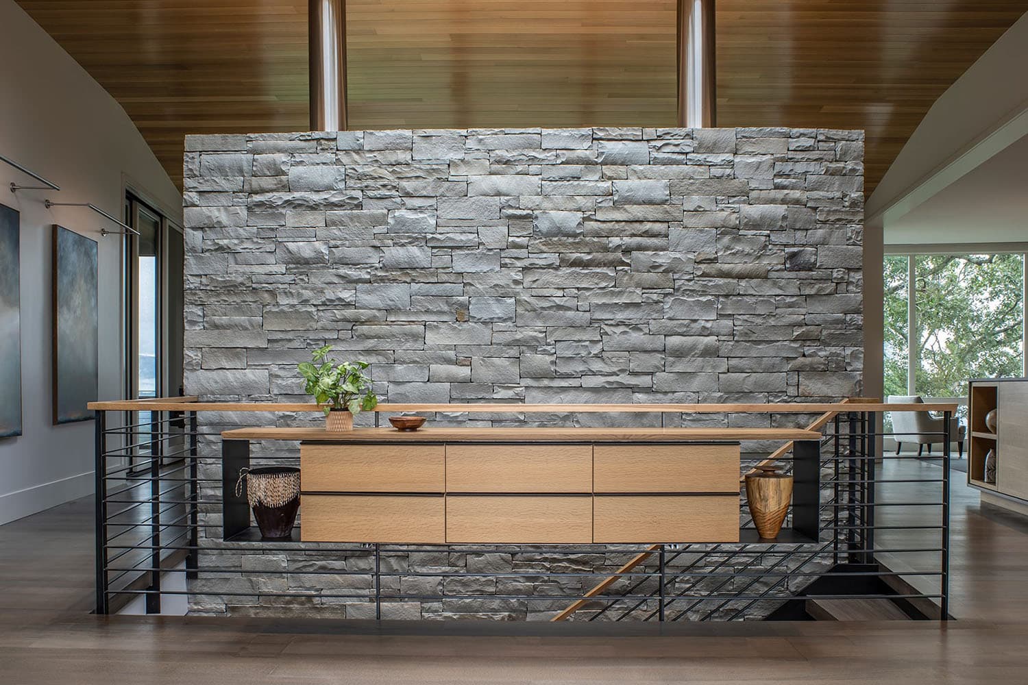 rustic modern mountain home entry with a stone accent wall and console table