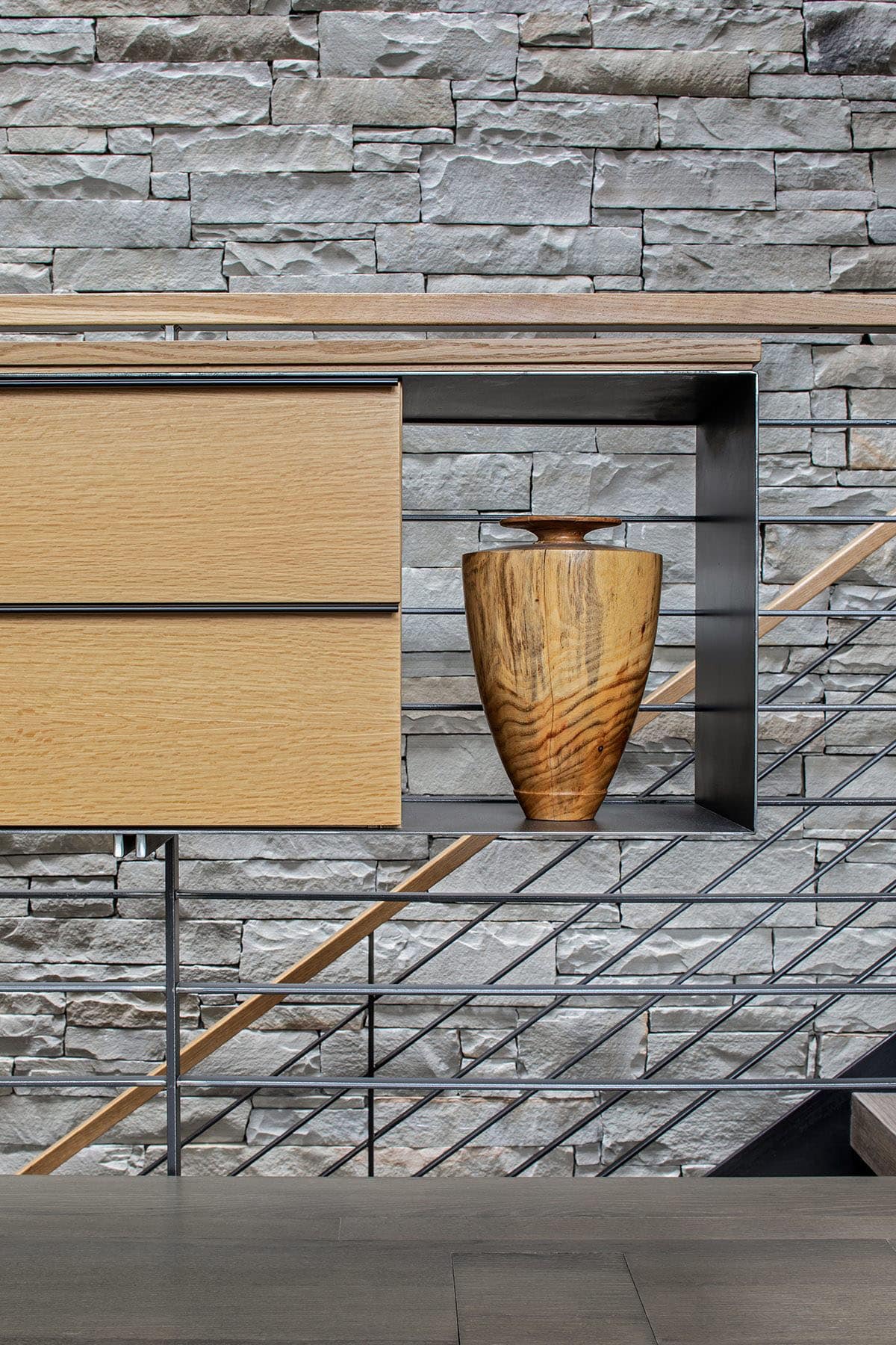 rustic modern staircase with a stone accent wall