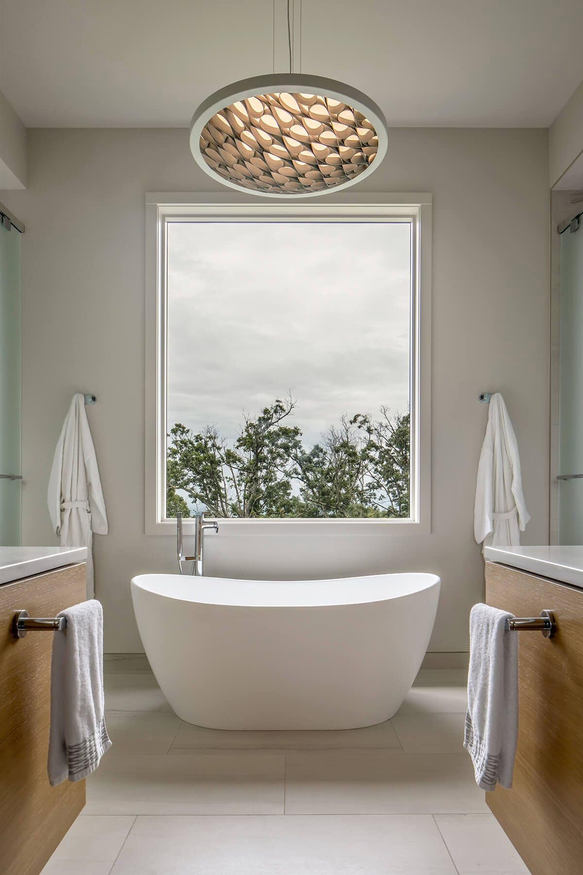 rustic modern bathroom with dual vanities and a soaking tub
