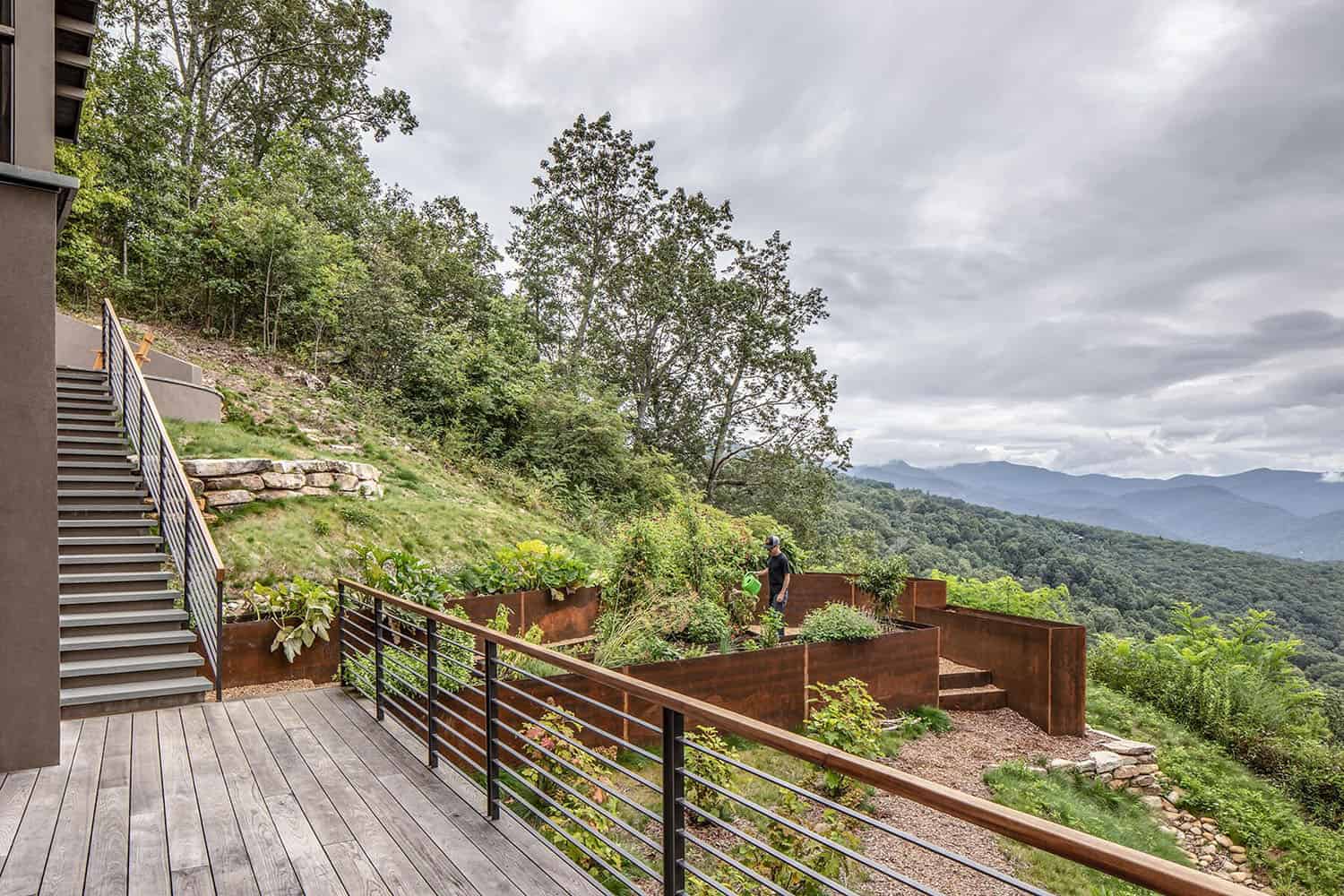 rustic modern mountain home exterior with a deck and gardens