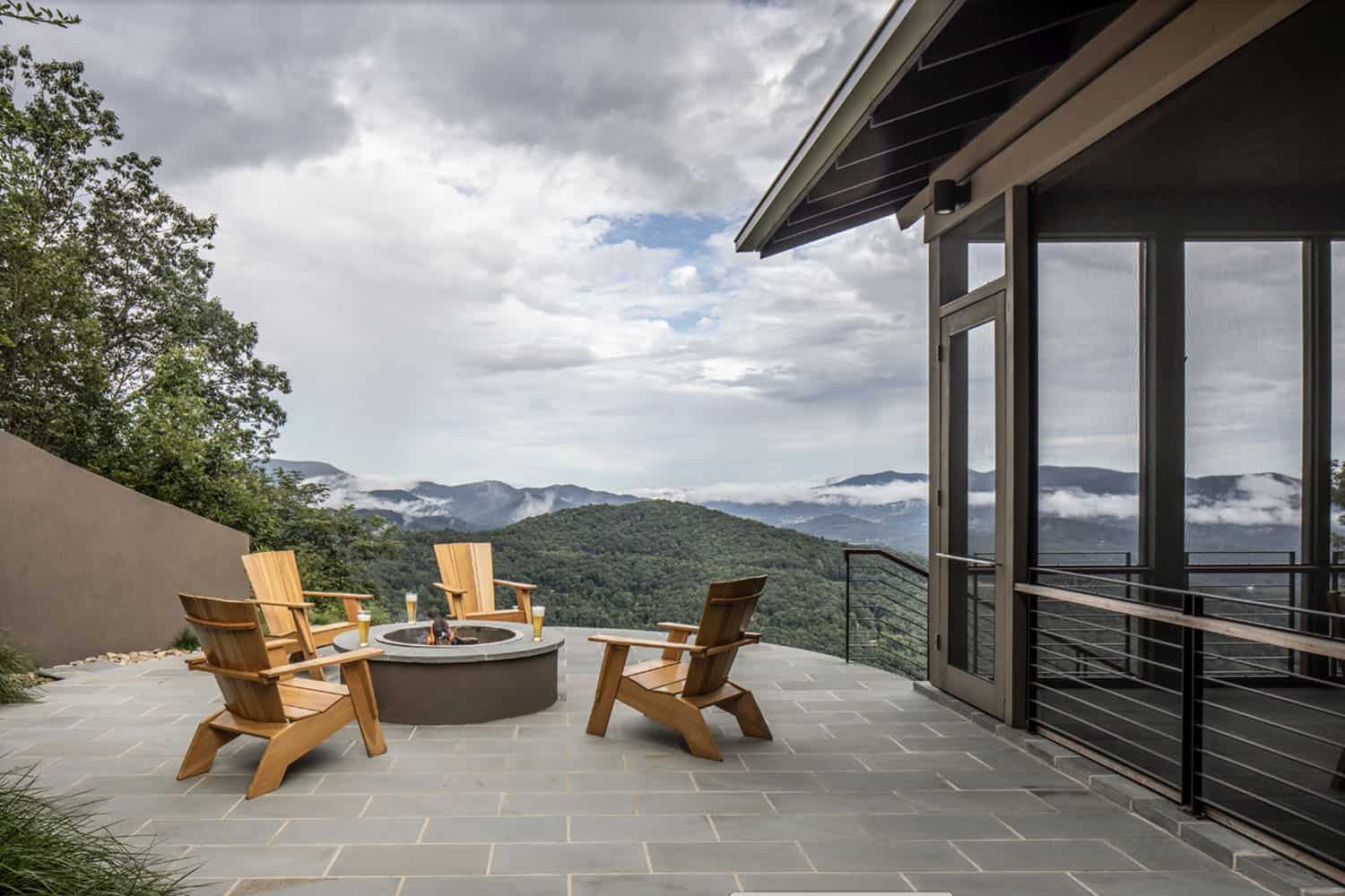 rustic modern mountain home exterior patio with a fire pit