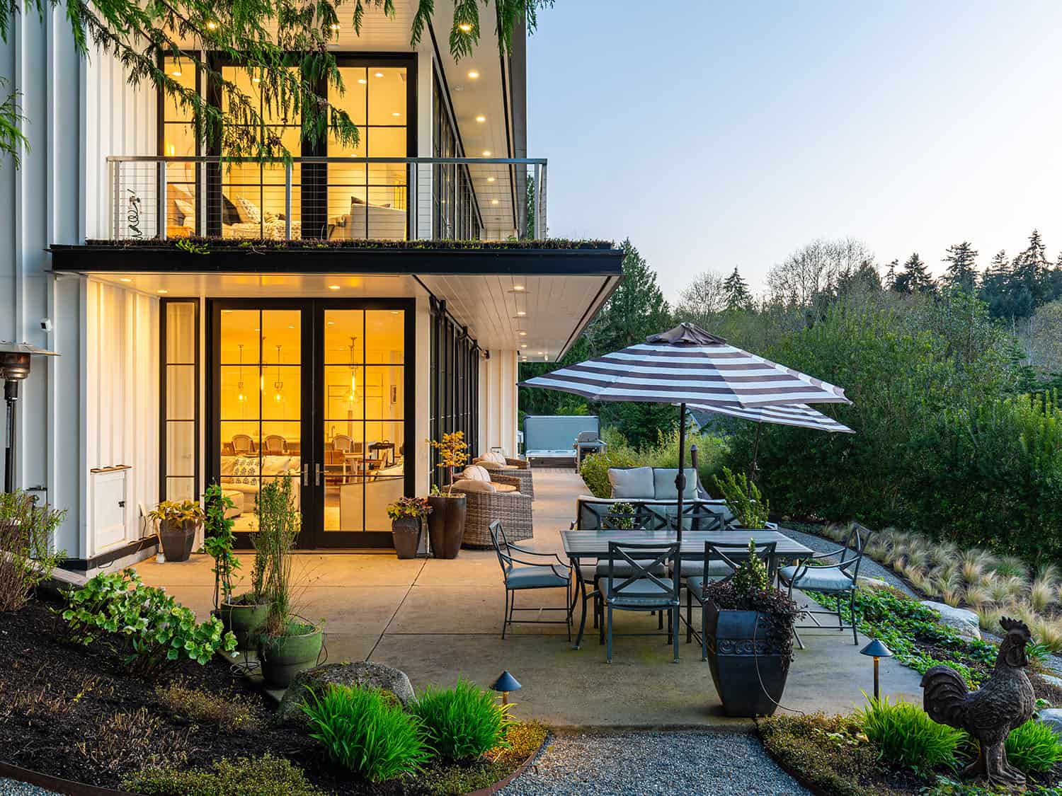 modern waterfront home exterior patio at dusk