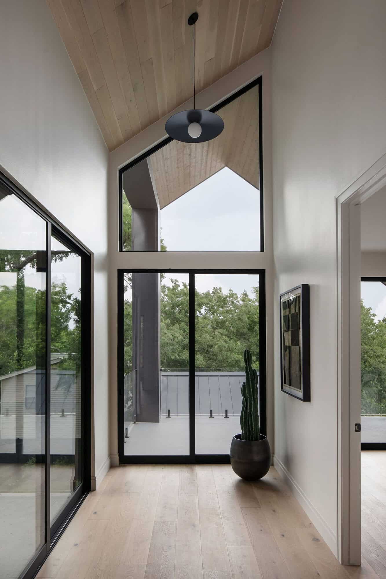 modern hallway with a tall ceiling and large window