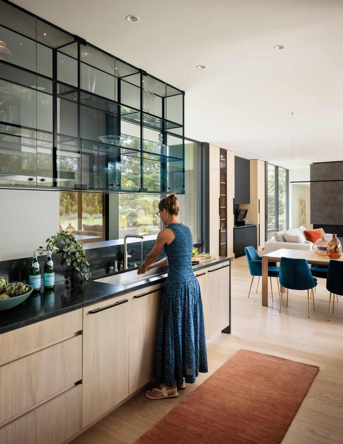 modern kitchen sink wall with a view into the dining and living room