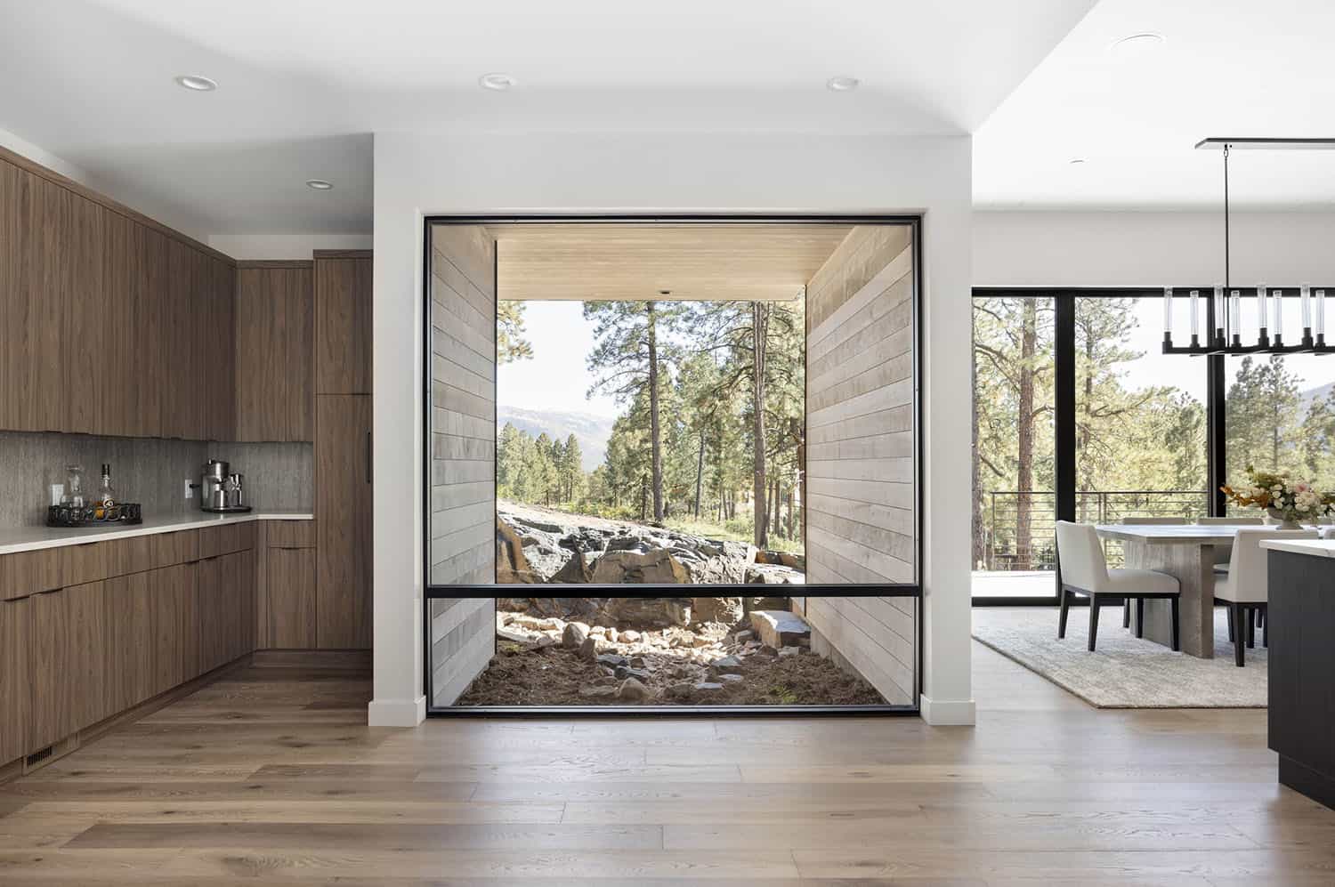 modern kitchen and dining room with a large window