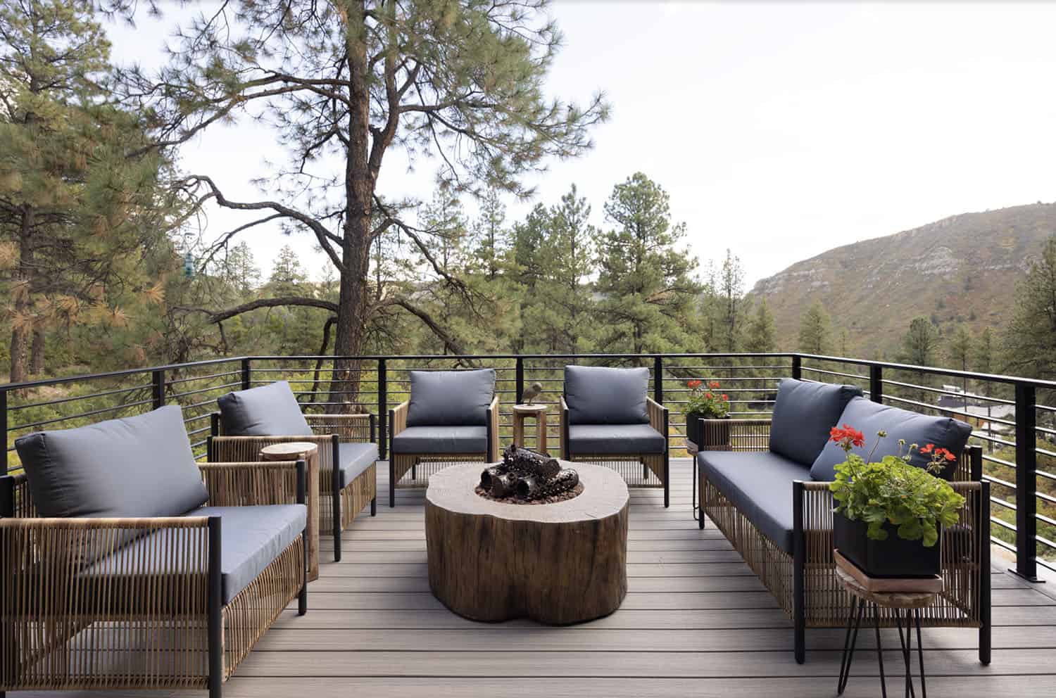 modern mountain home exterior with a deck and outdoor furniture