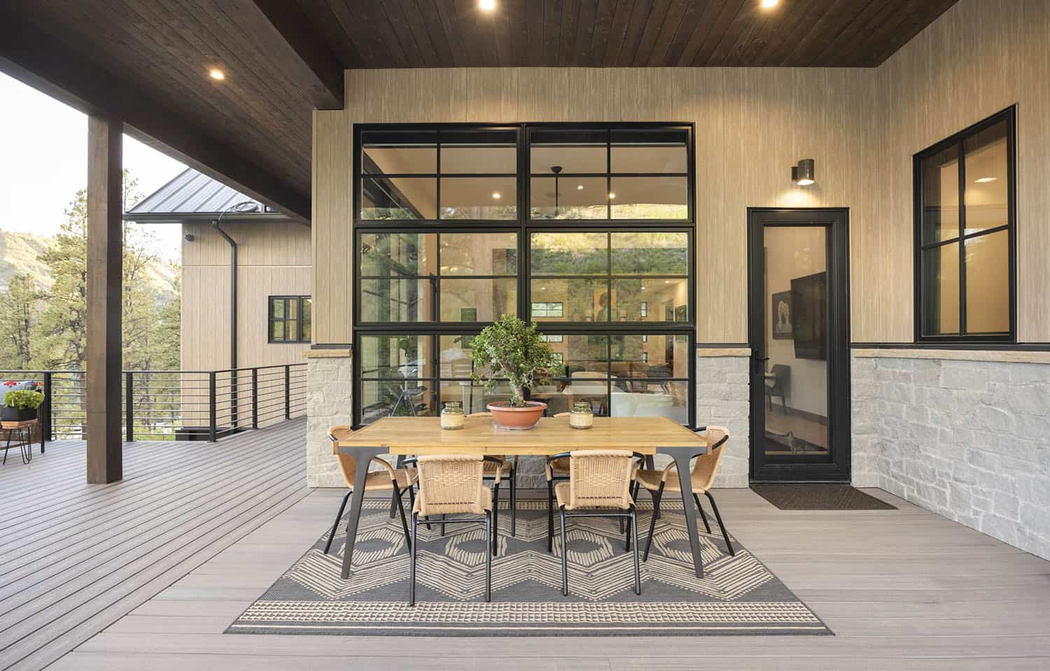 modern mountain home exterior with a deck and alfresco dining