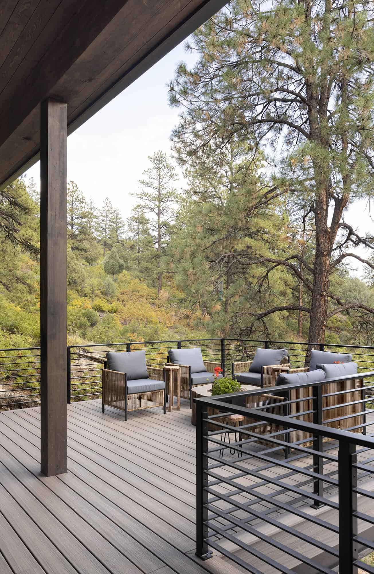 modern mountain home exterior with a deck and outdoor furniture
