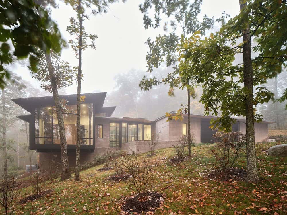 modern mountain house exterior with towering trees