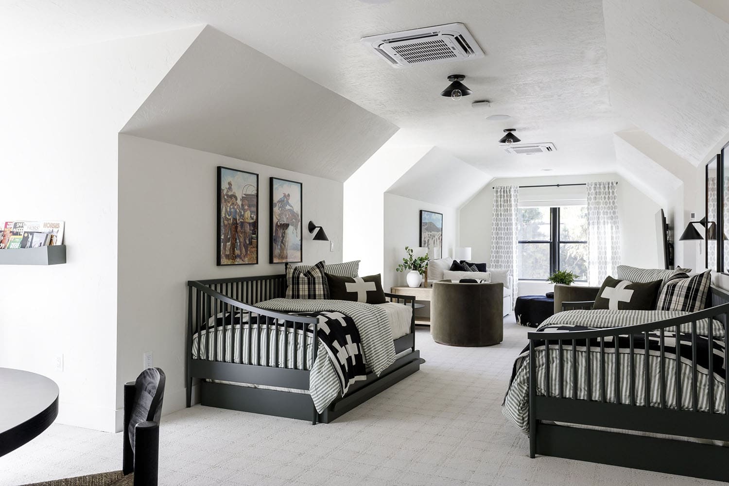 rustic bunk space with trundle beds and a sleeper sofa
