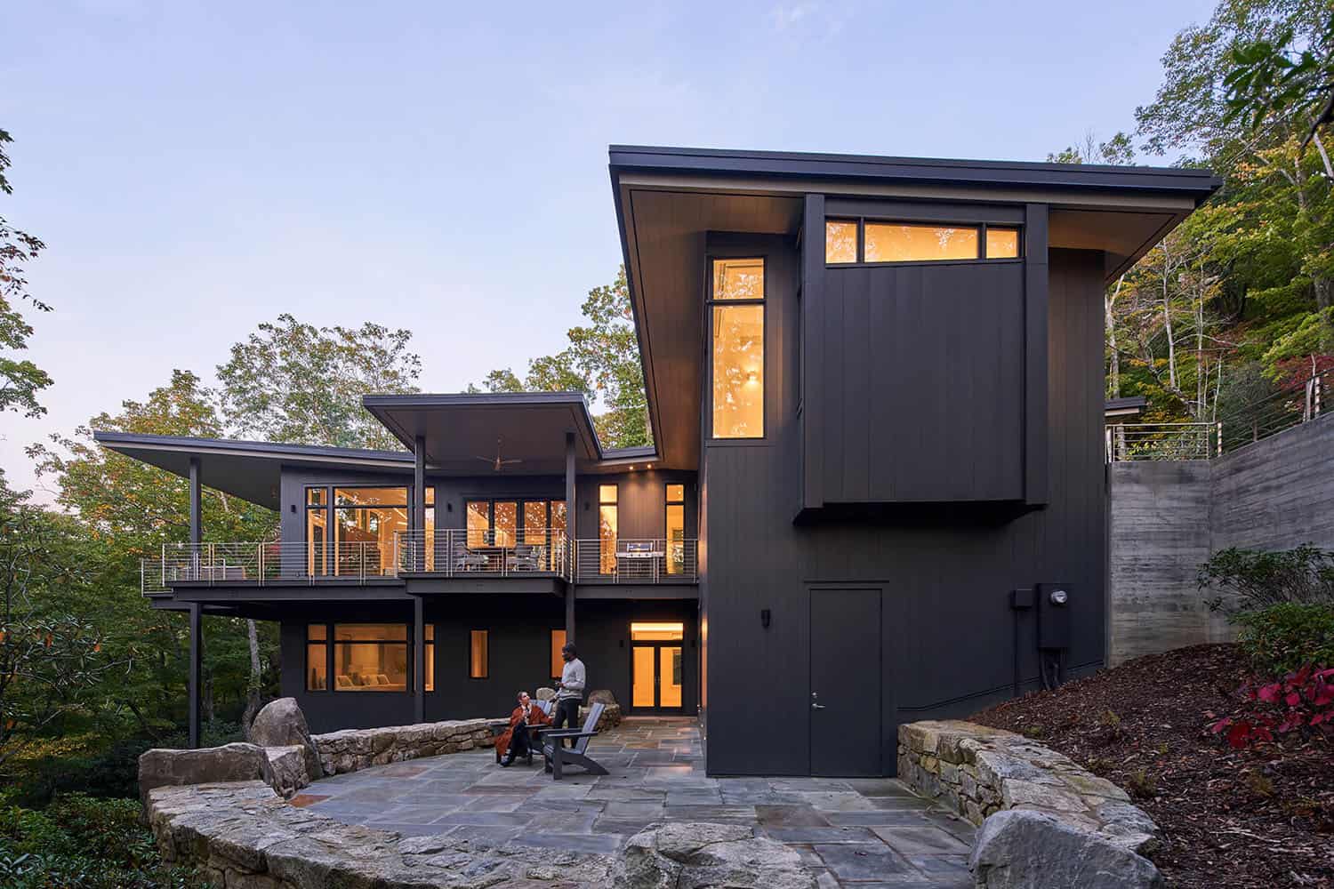 modern treehouse-like home exterior with a large patio