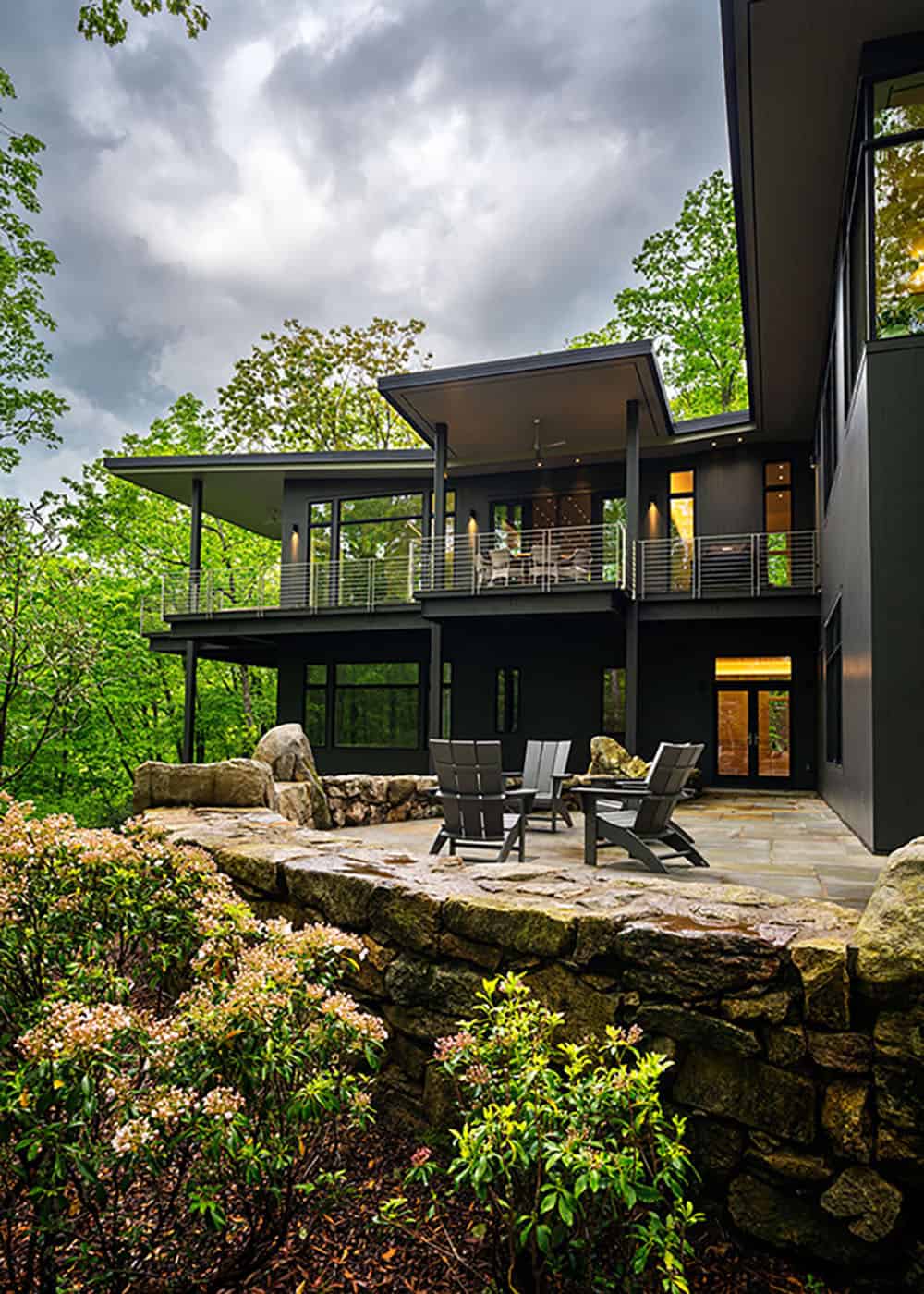 modern treehouse-like home exterior with a large patio