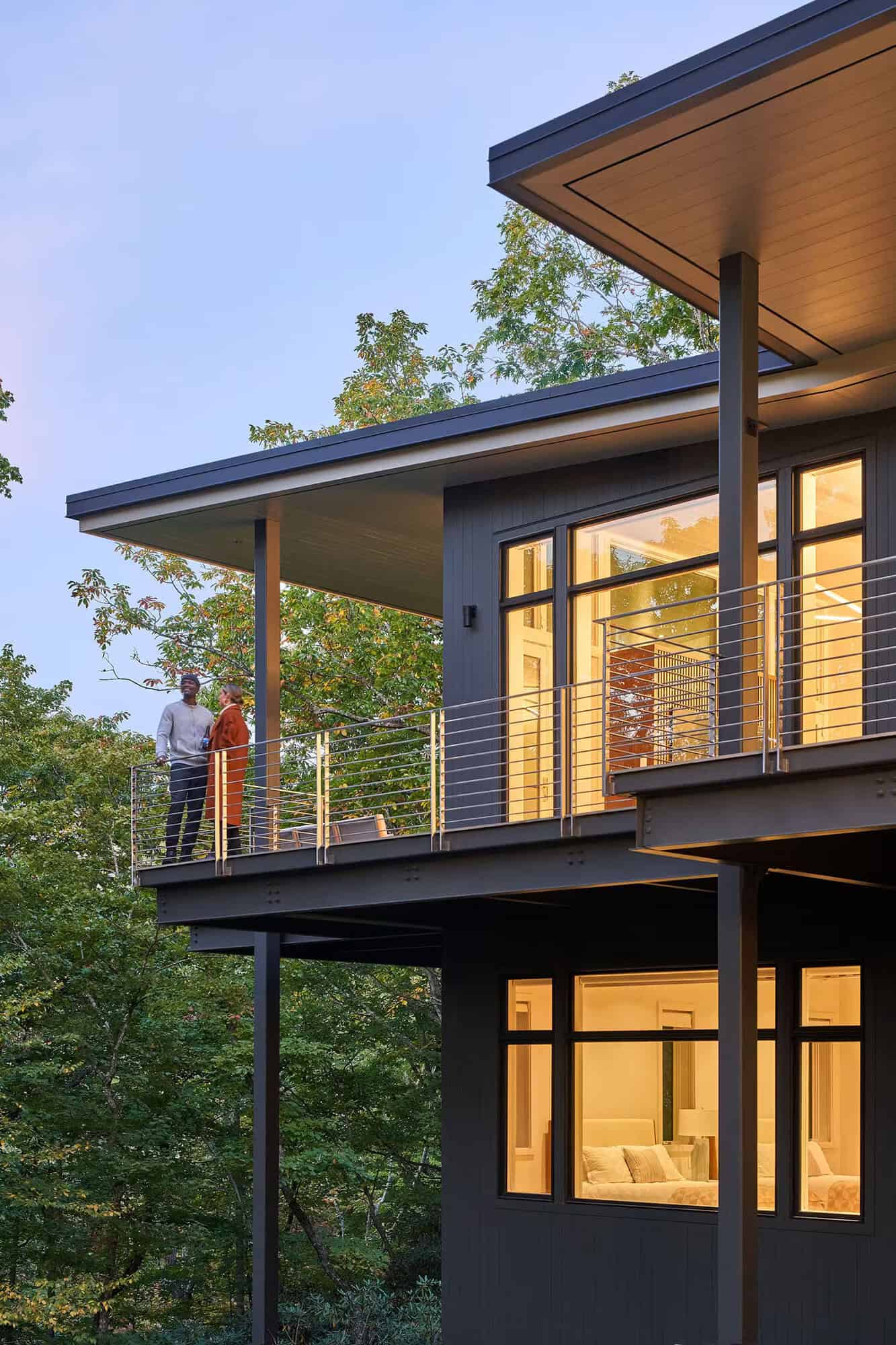 modern treehouse-like home exterior at dusk