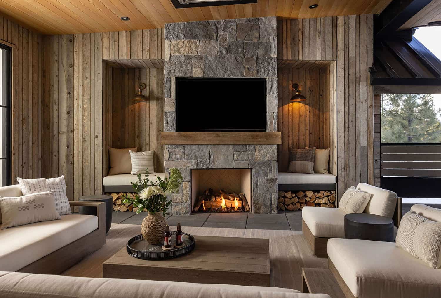 modern farmhouse style covered patio with a fireplace and built-in seating