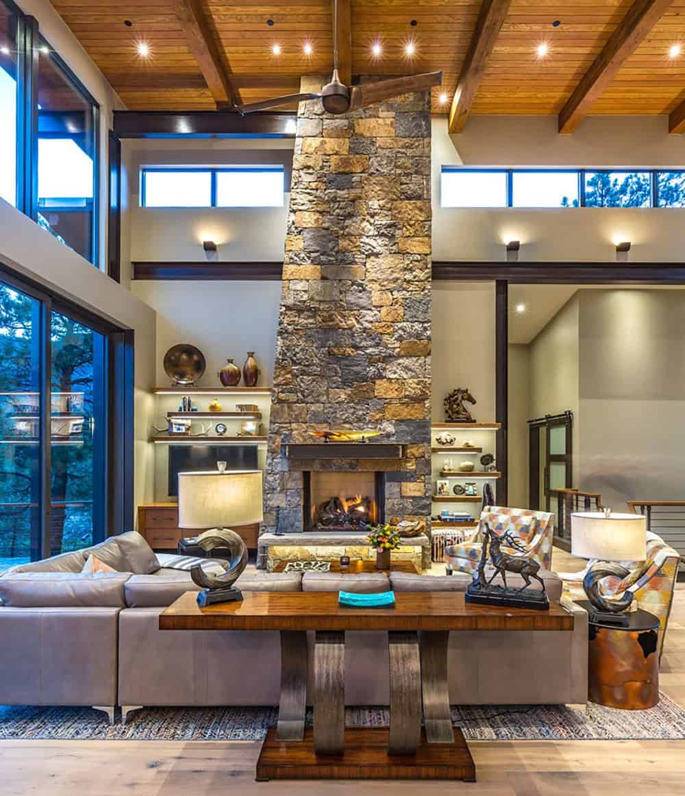 A large living room with a stone fireplace