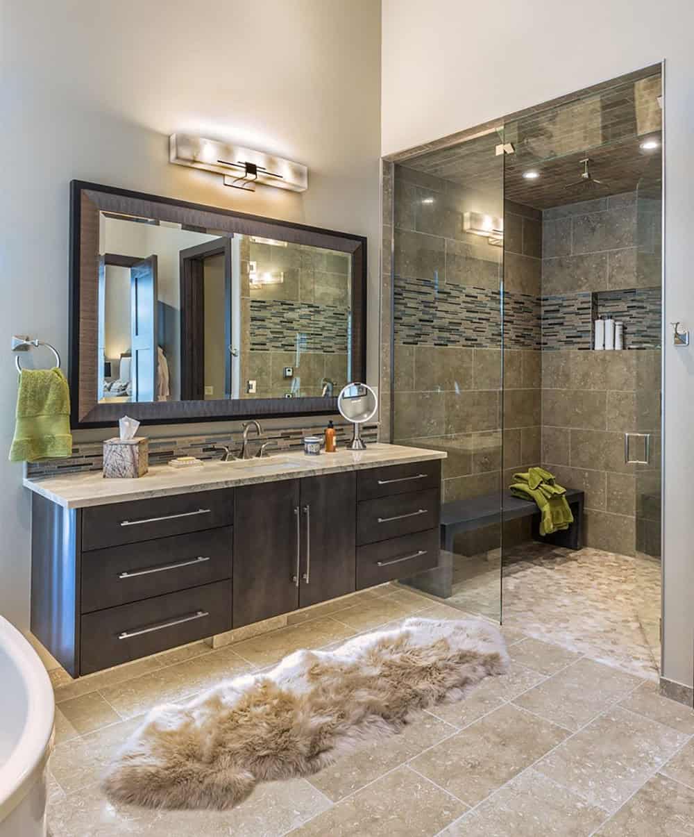 A bathroom with a walk in shower and a large vanity