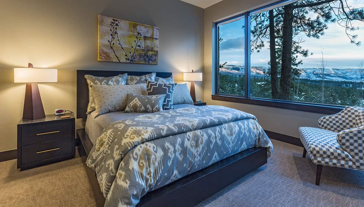 A bedroom with a view of the mountains and a bed