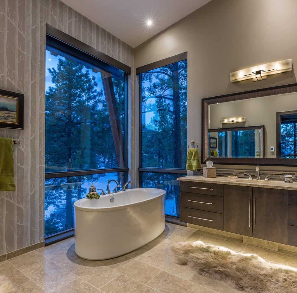 rustic bathroom with a soaking tub and a large window