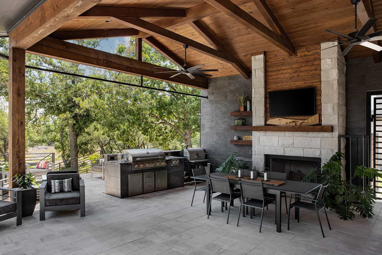 organic modern home exterior with a covered patio with an outdoor grill and dining area