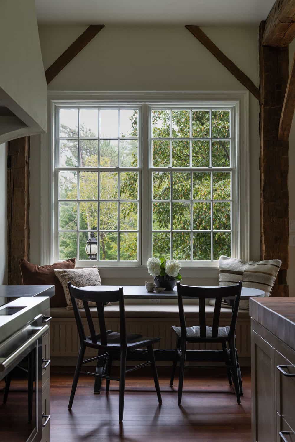 contemporary kitchen and breakfast nook with a banquette and large window