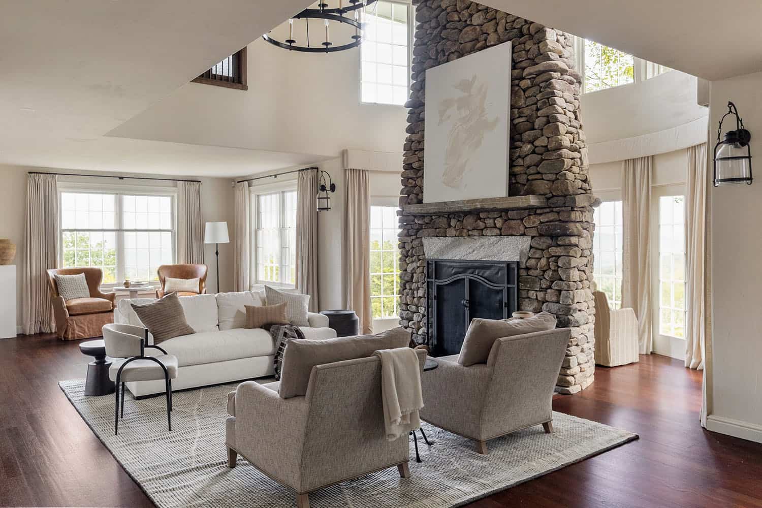 contemporary living room with a stone-clad fireplace