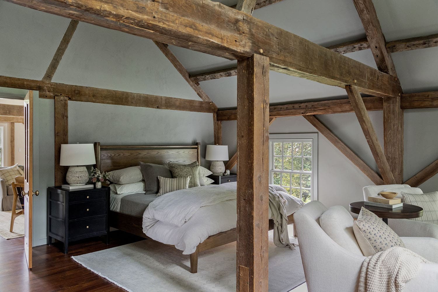 contemporary bedroom with rustic wood beams