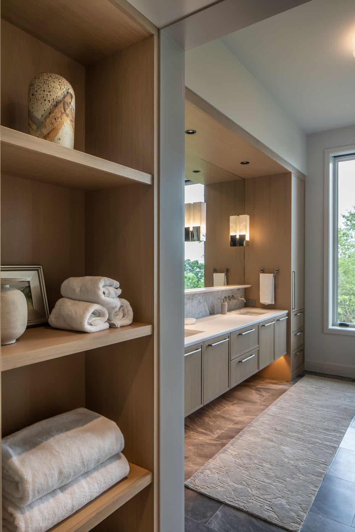 modern bathroom with open shelving and a large vanity
