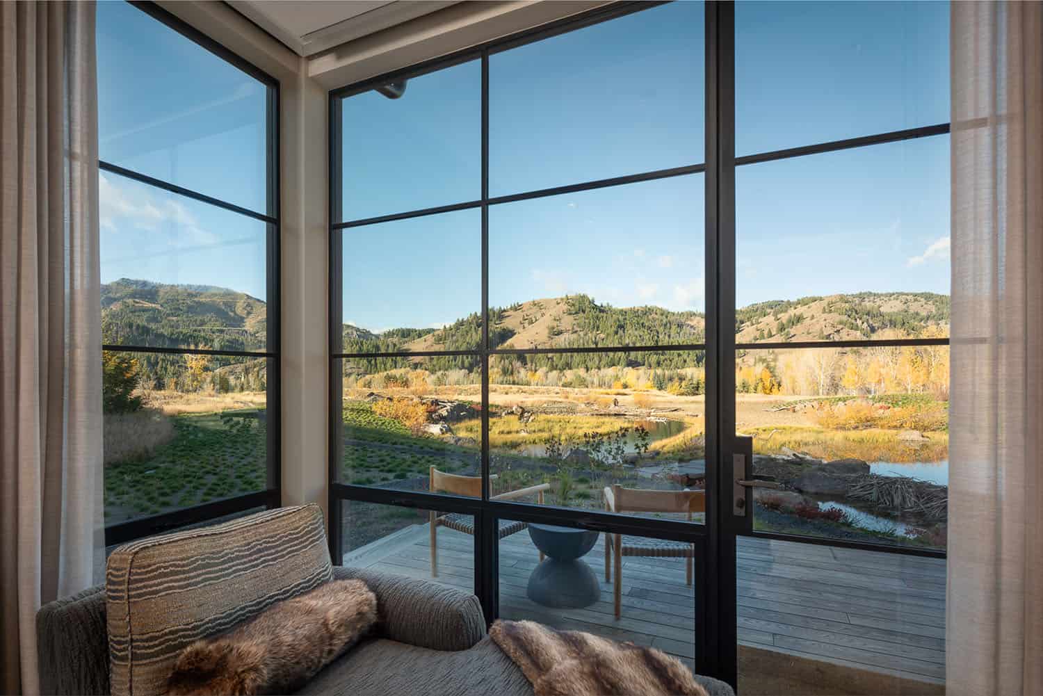modern bedroom with a glass door leading out to a private patio