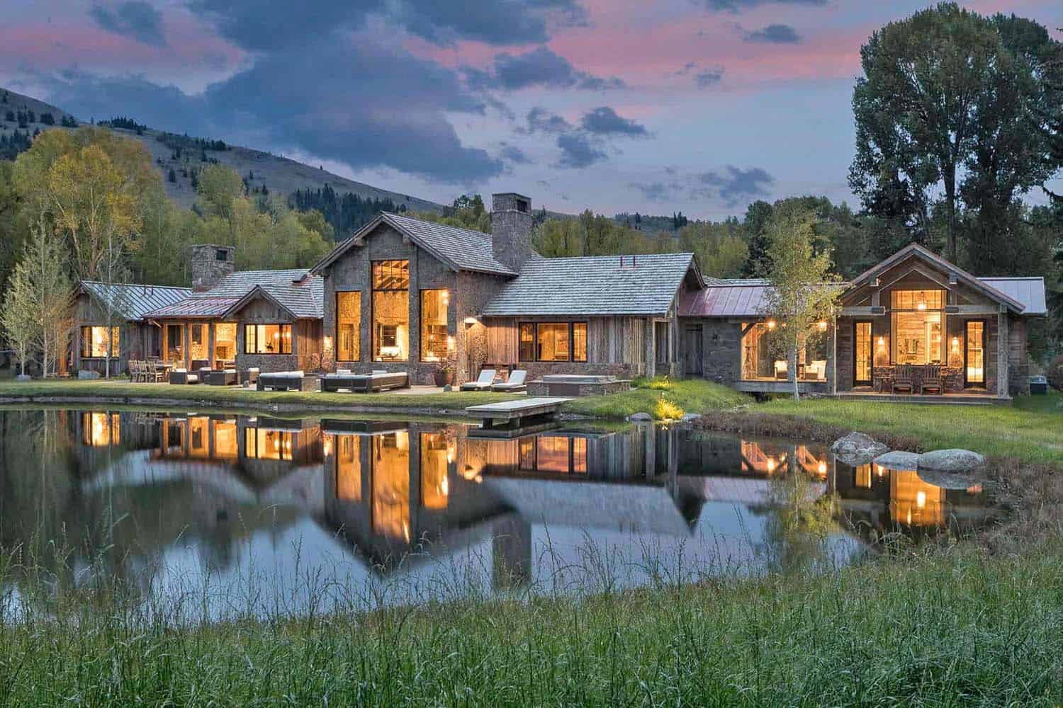 A large home with a pond and mountain views