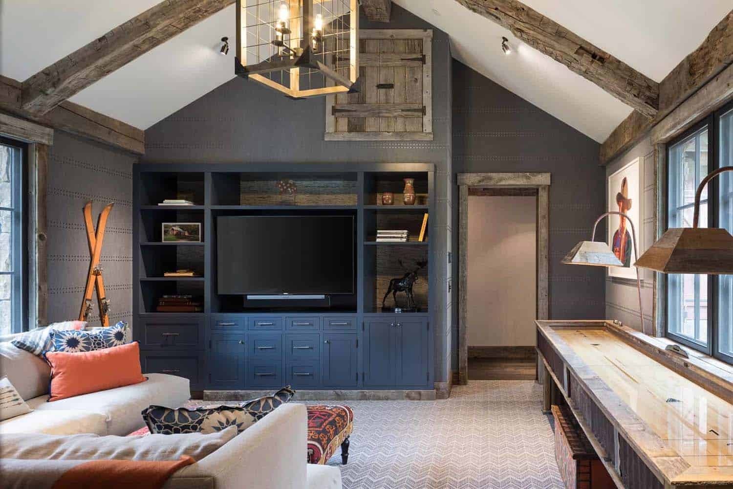 modern rustic family room with a sofa and a tv wall