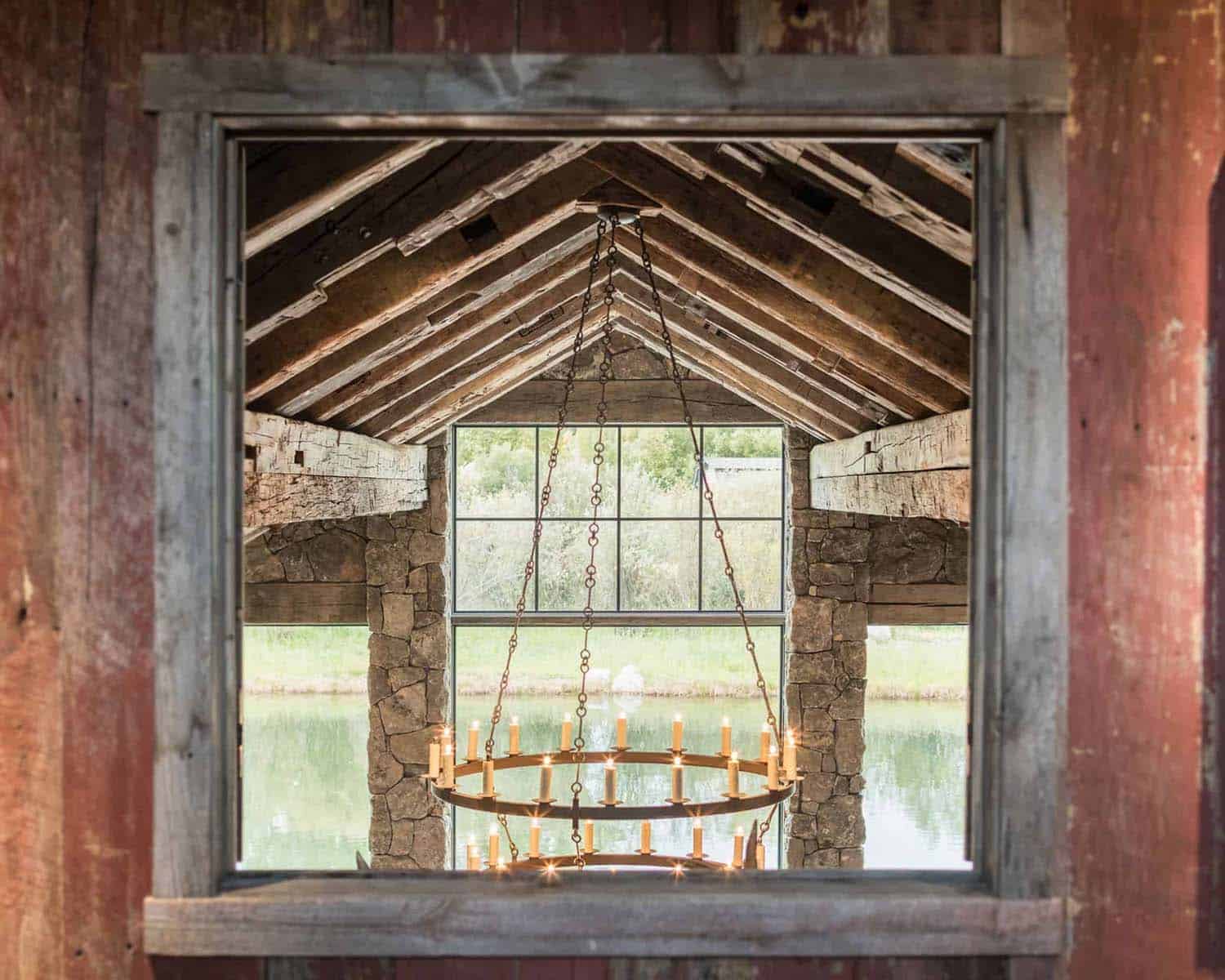 detail of a chandelier hanging from a rustic wood ceiling