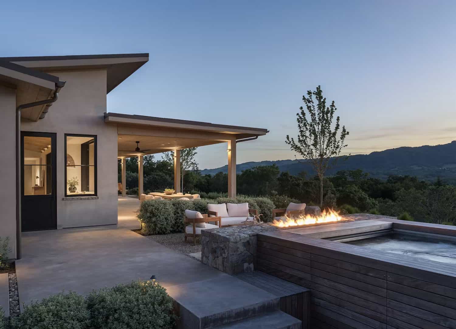 contemporary home exterior with a patio at dusk