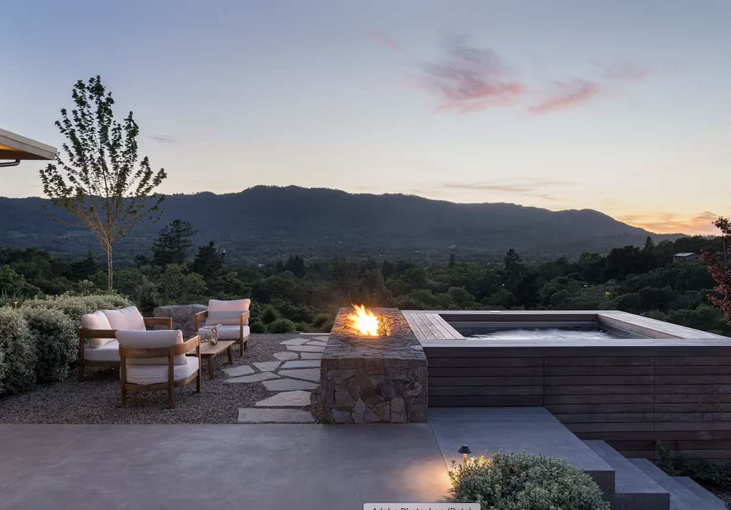 contemporary home exterior with a patio at dusk