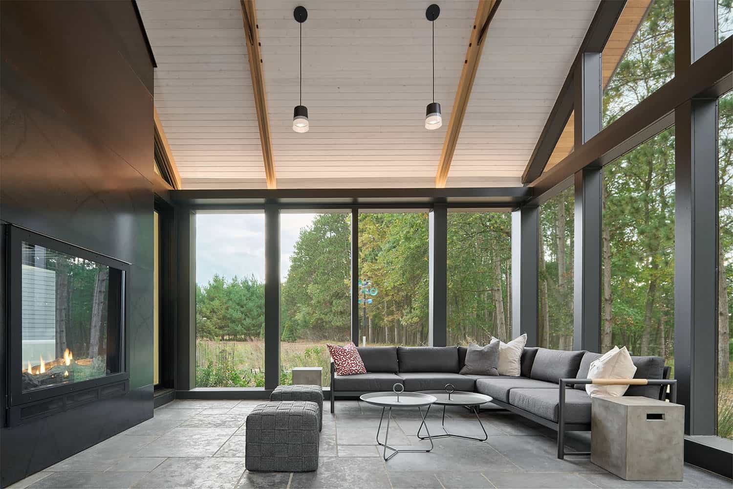 modern screened porch with a fireplace