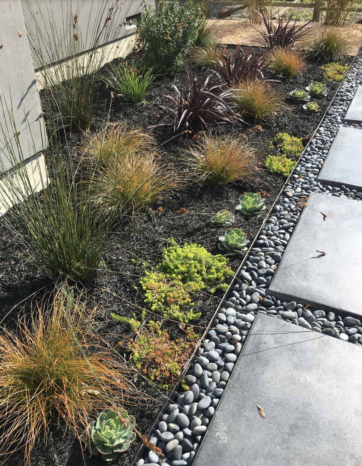concrete pathway entrance with landscape edging and garden bed