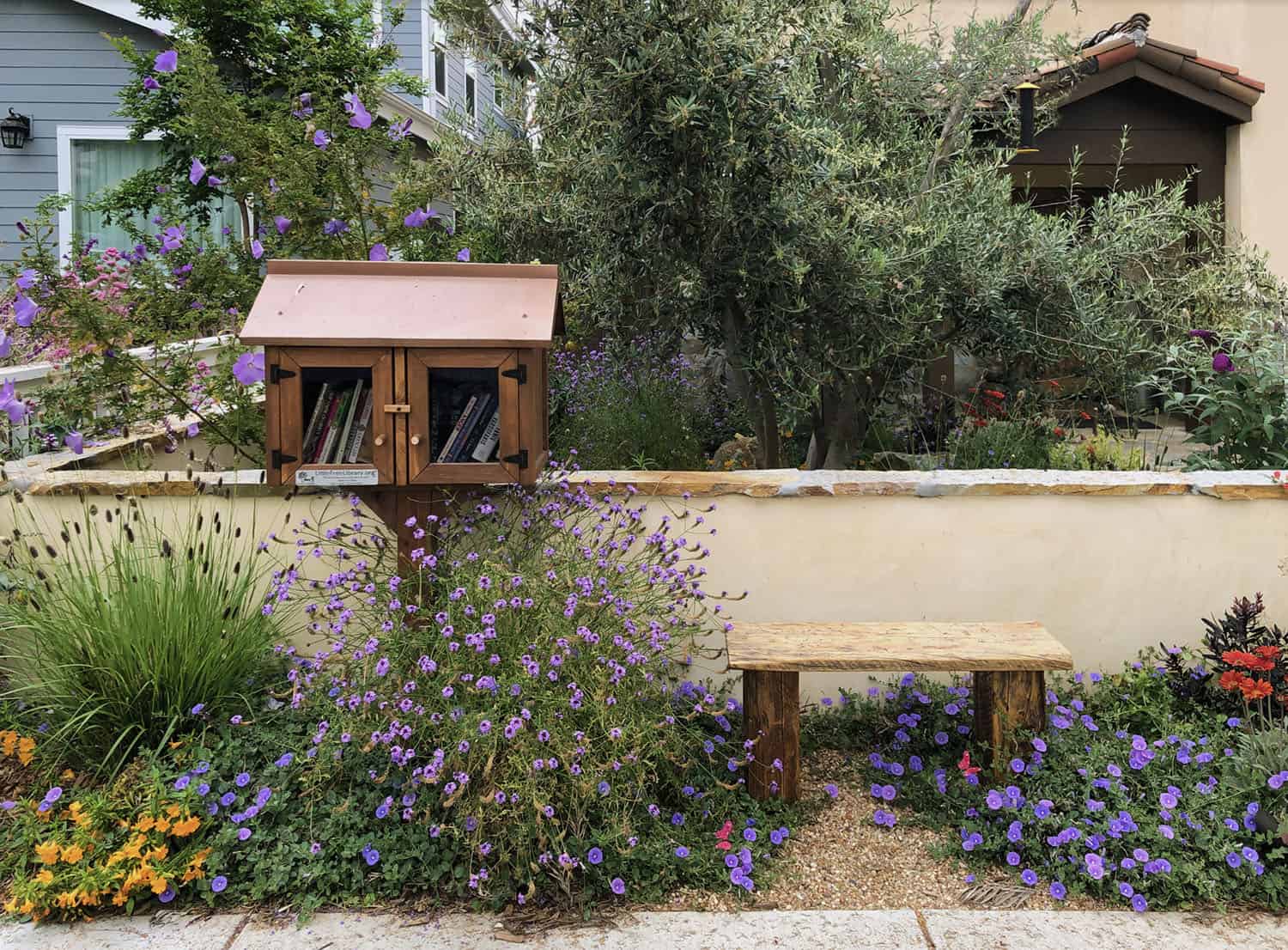 small front yard with a bench and landscaping