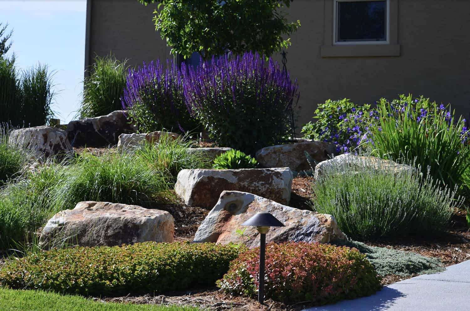 small front yard garden with large boulders
