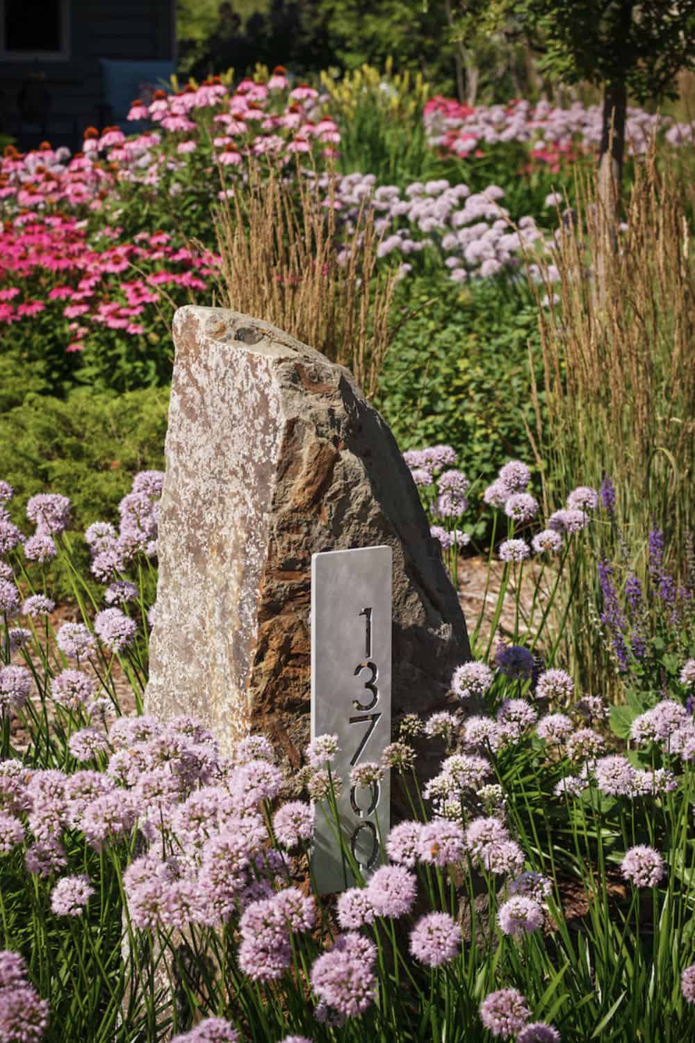 address marker surrounded by a colorful garden