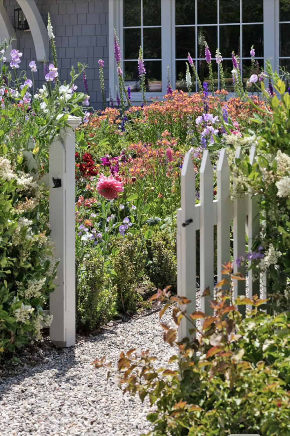 picket post fence surrounded by wildflowers