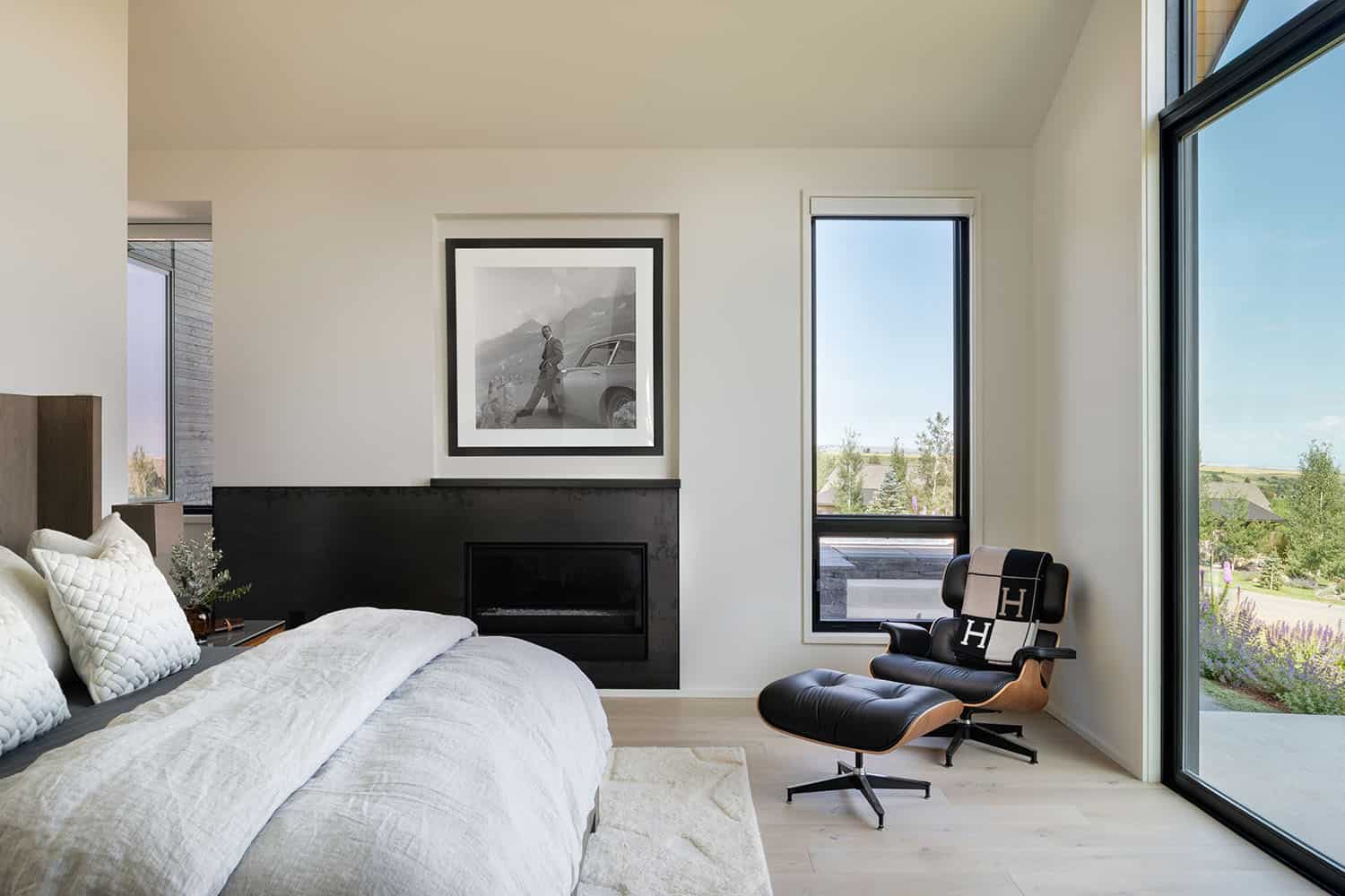 modern bedroom with an eames chair and ottoman
