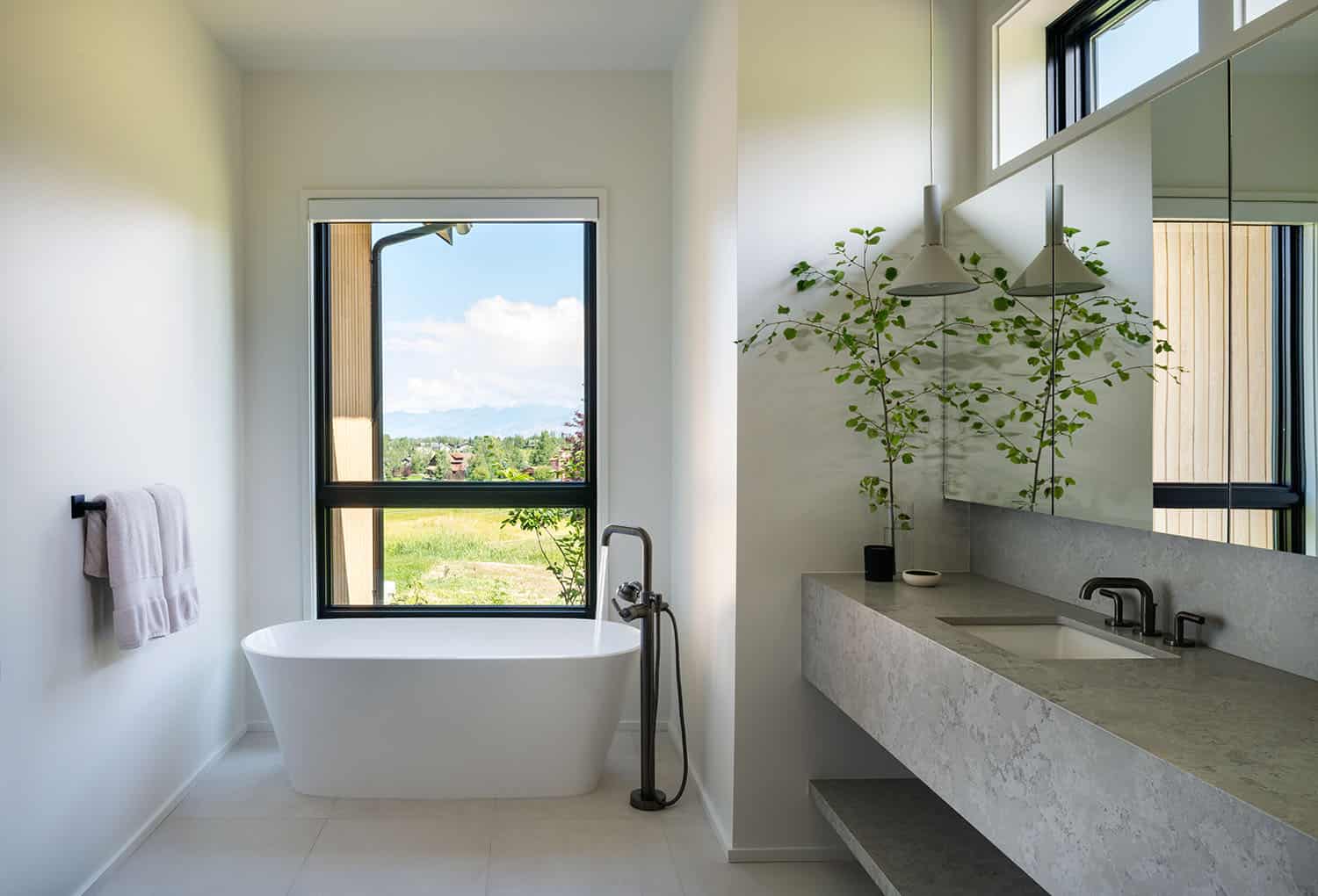 modern bathroom with a vanity and freestanding tub