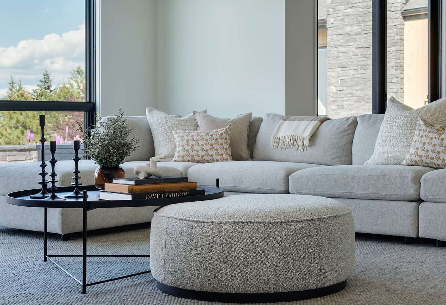 modern living room with a sofa and round ottoman