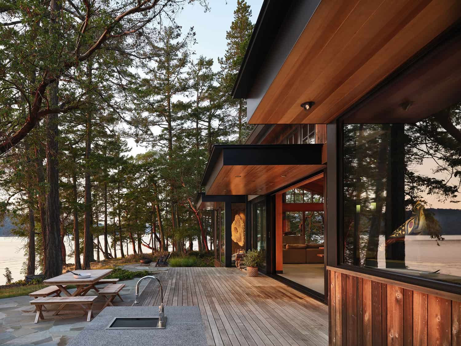 rustic waterfront house exterior with a large patio