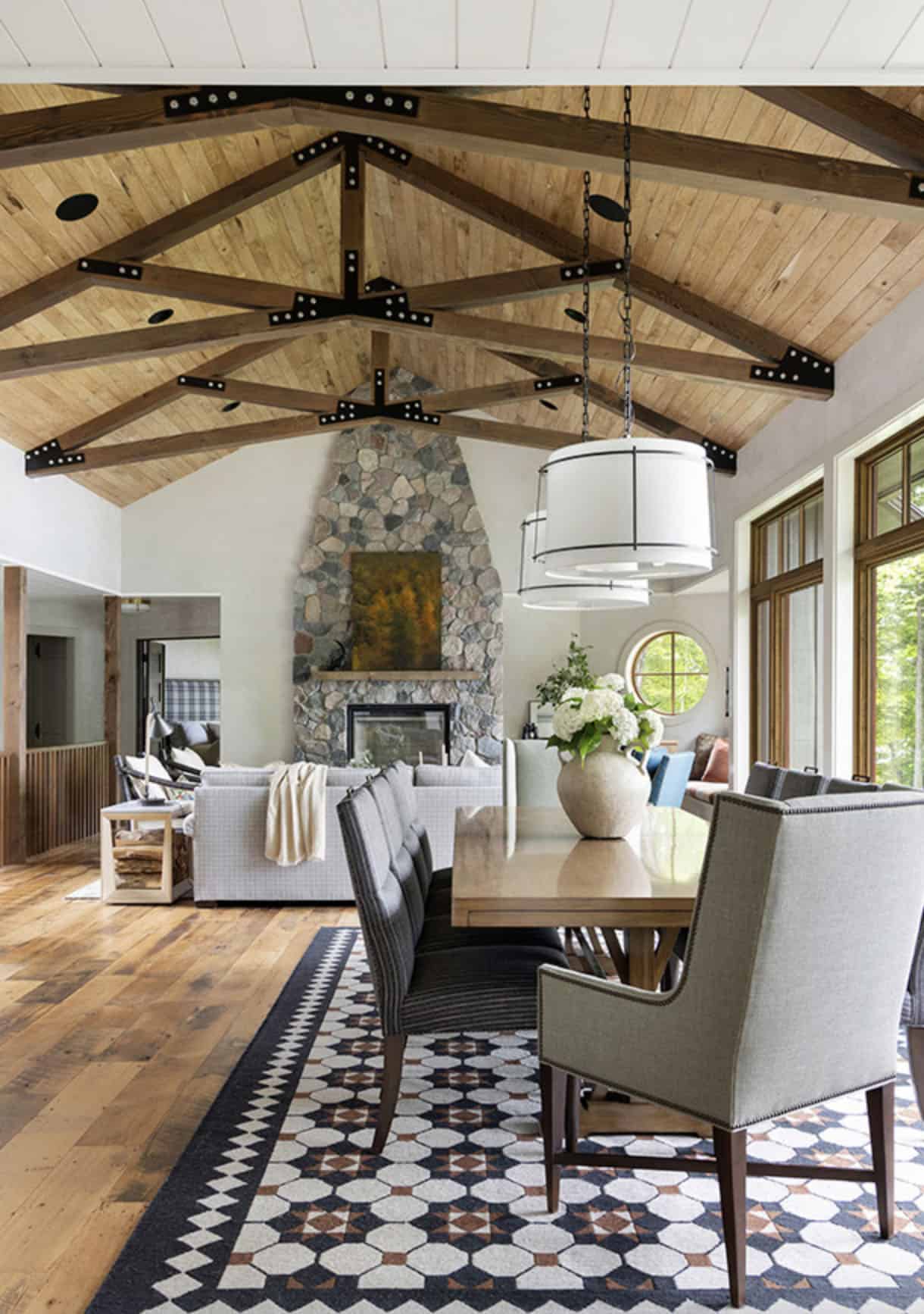 transitional style dining and living room with a fireplace