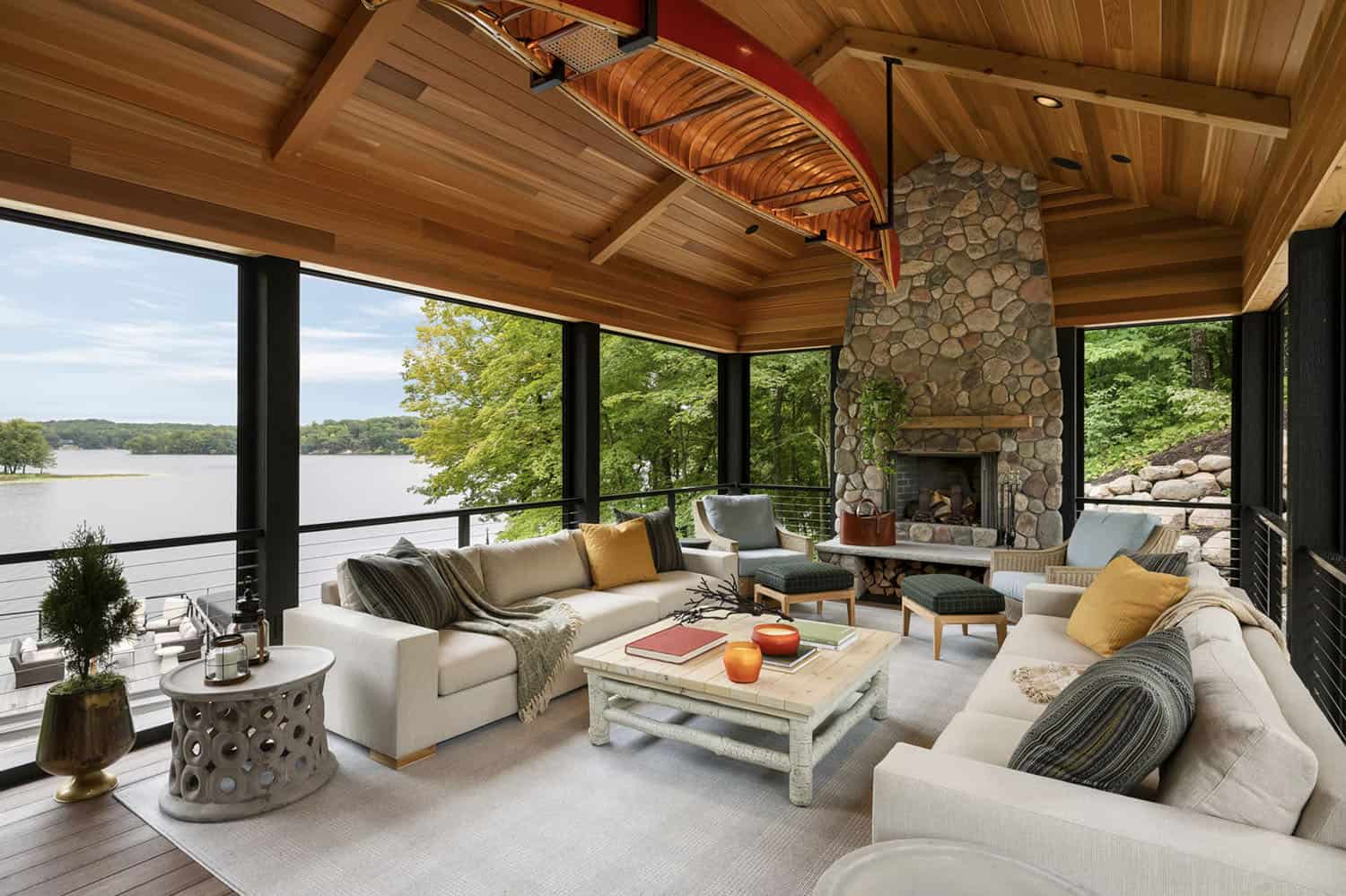 transitional style screened porch with a fireplace