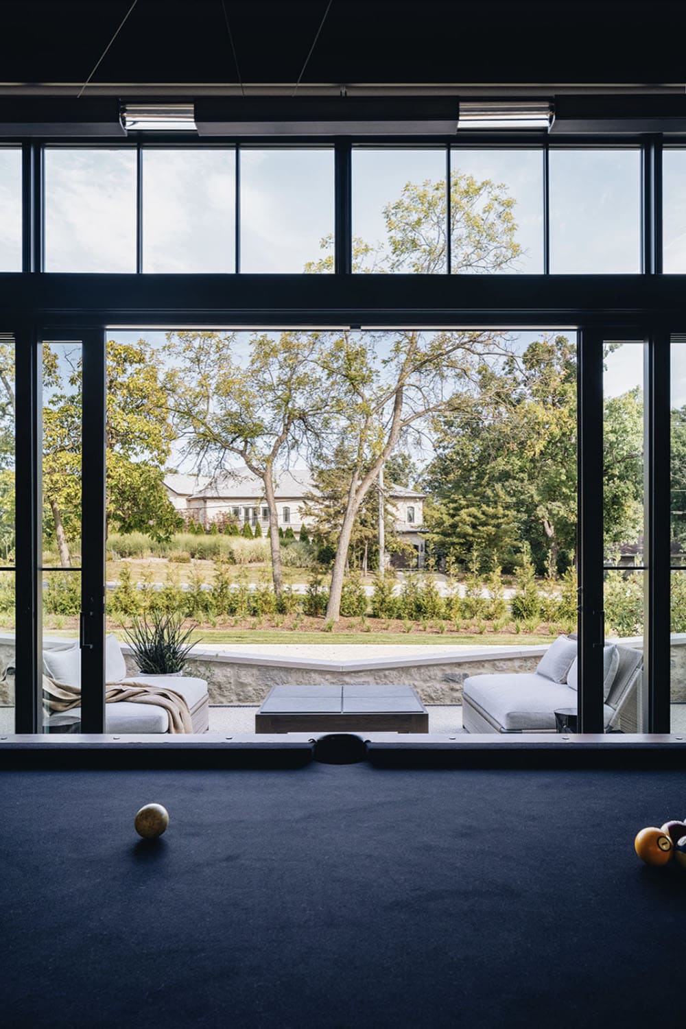 transitional family room with a pool table and a view of the patio