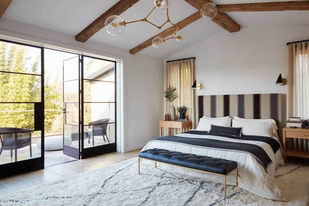 urban farmhouse bedroom with french doors and a private balcony